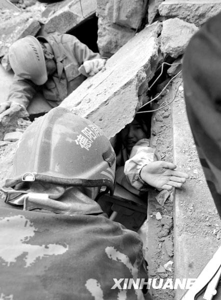 2008年5月13日，救援人员在绵竹市汉旺镇武都小学地震废墟中营救被困学生。